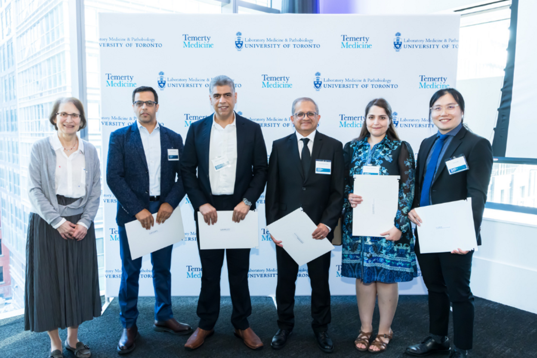 A group of people holding certificates