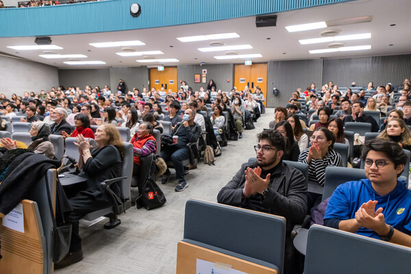 Attendees applauding at the LMPSU Research Conference