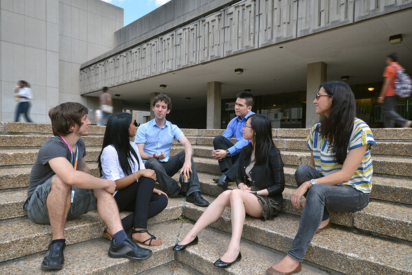 a group of students talking outside the medical sciences building