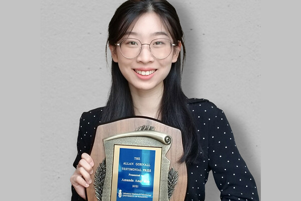 a young woman holding a certificate