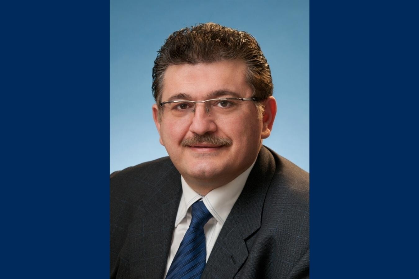 Photo of Dr. Danny Ghazarian on a blue background.