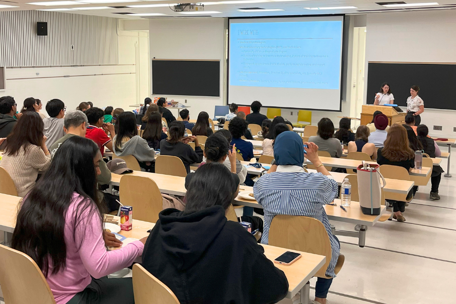 A classroom full of people listening to a lecture