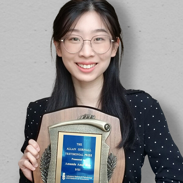 a young woman holding a certificate